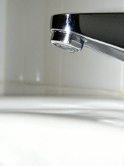 Water drops falling from a tap.